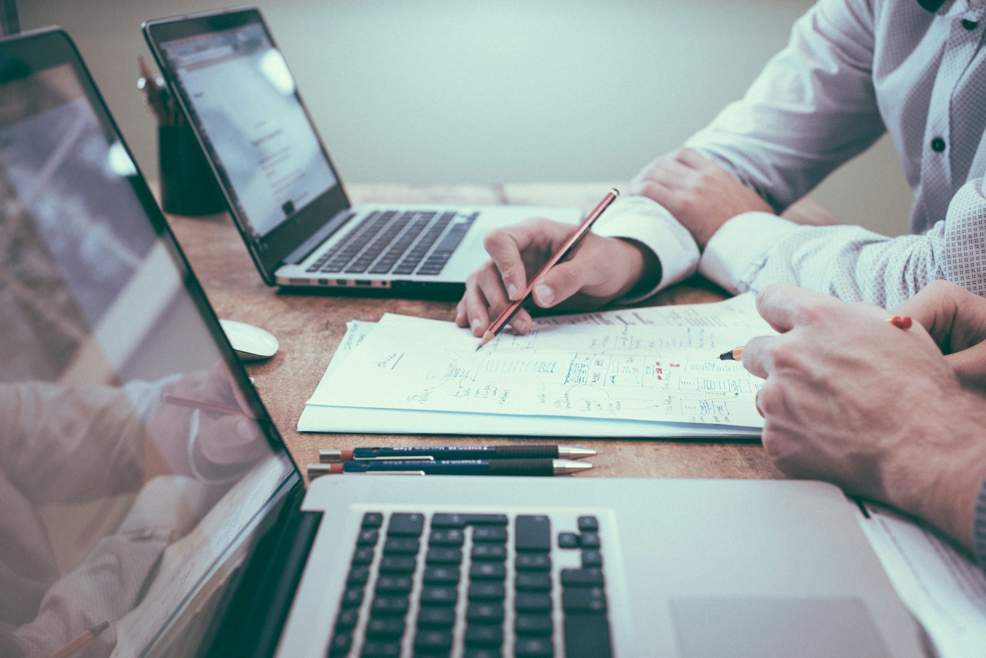 An investor and coach reviewing a deal together at a desk
